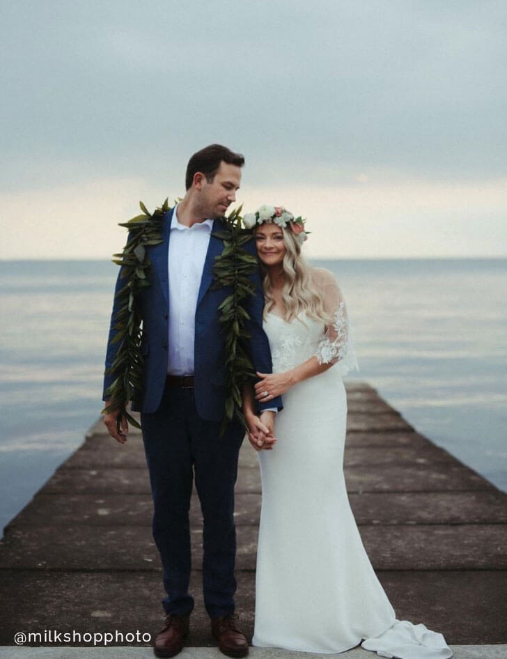 Сouple wearing a white gown and a black suit