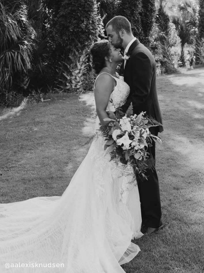 Сouple wearing a white gown and a black suit