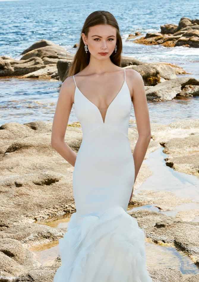 Model wearing a white gown by Love
