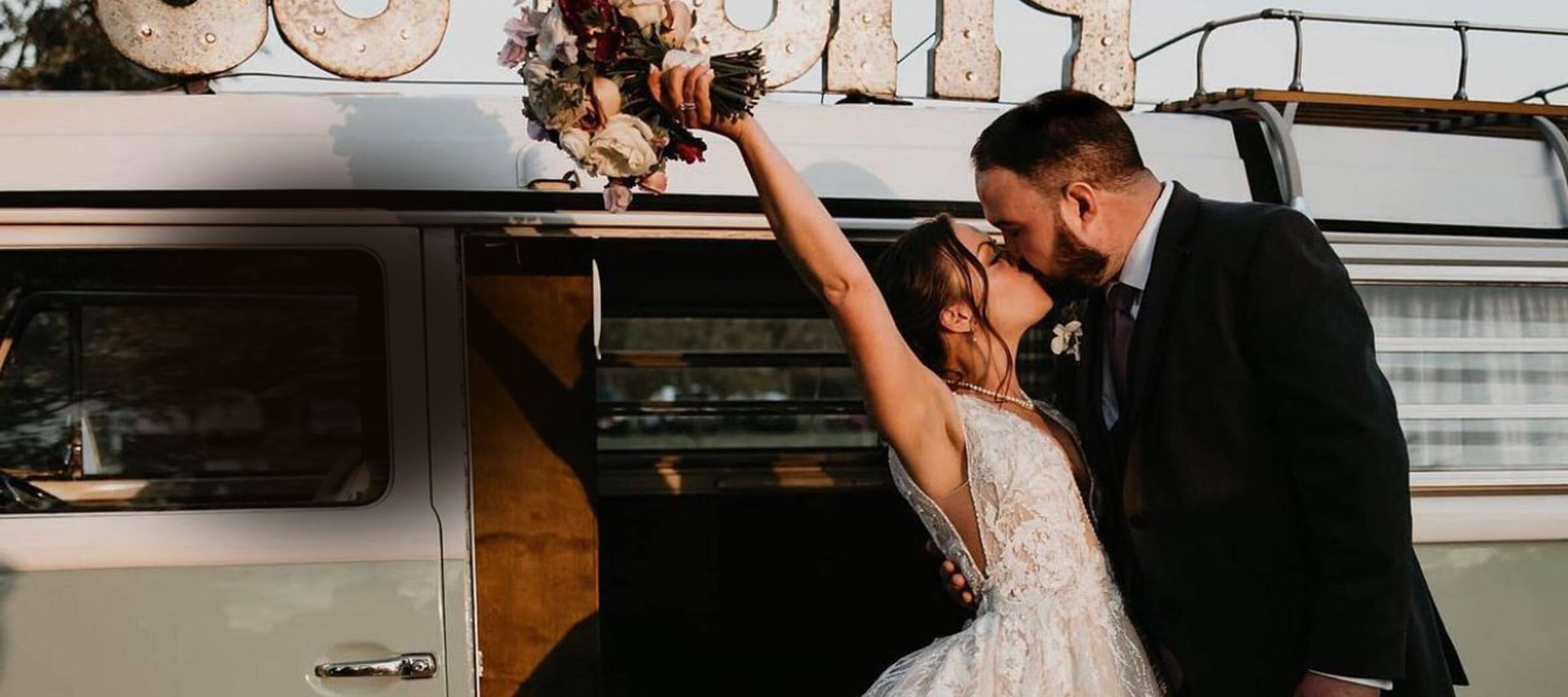 Сouple wearing a white gown and a black suit